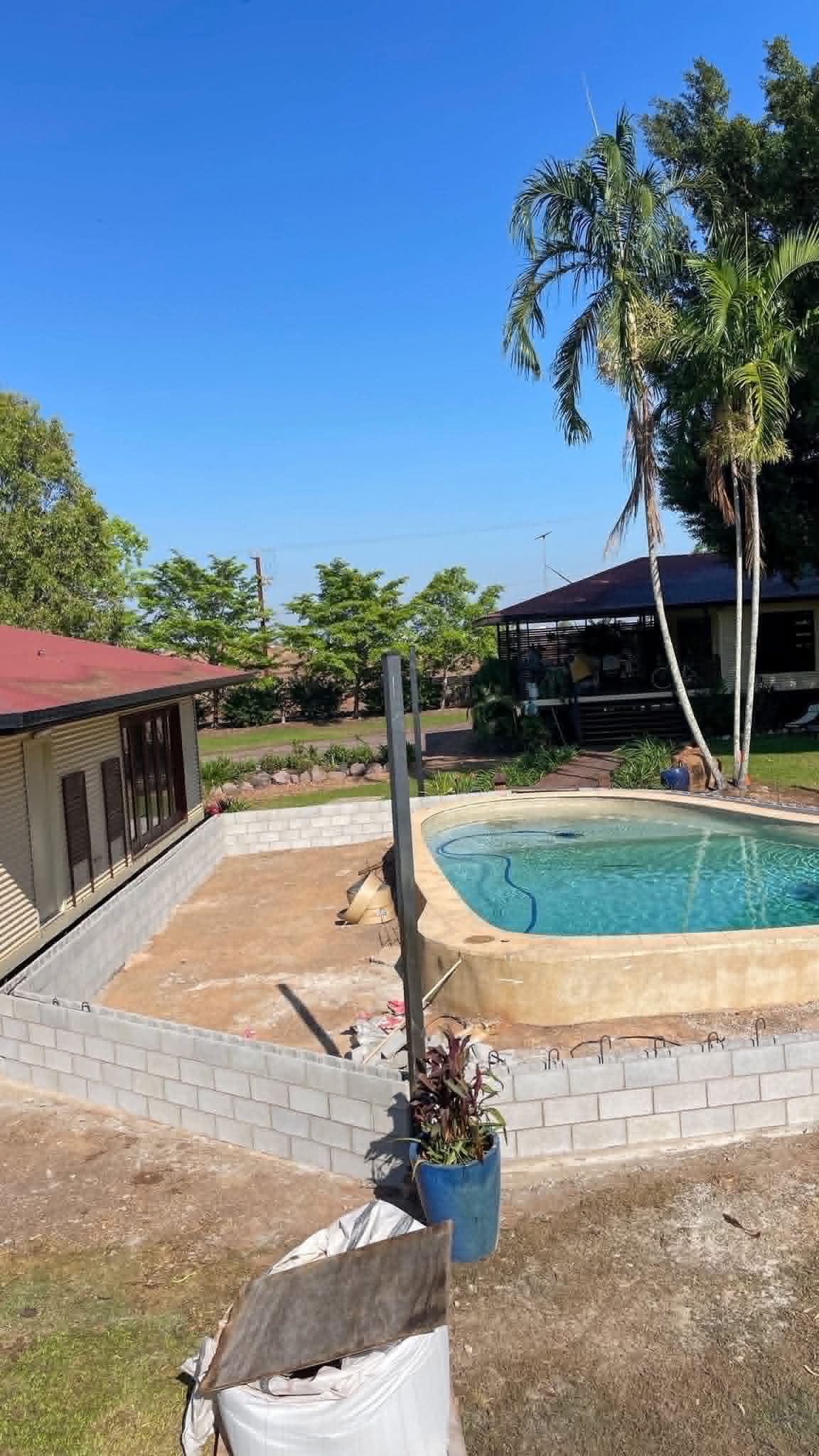 Pool surround retaining wall in block, tropical setting